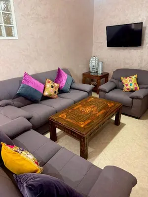 a living room with couches and a coffee table at Villa Rina in Sidi Rahal