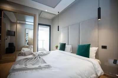 a bedroom with a large white bed with green pillows at Where to stay in Casablanca 2 bedrooms in Casablanca