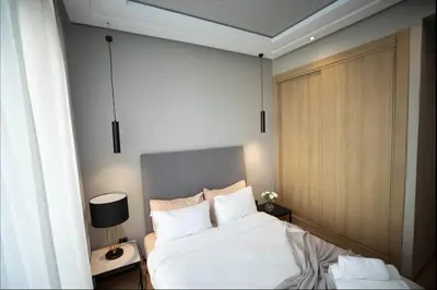 a bedroom with a bed with white sheets and pillows at Where to stay in Casablanca 2 bedrooms in Casablanca
