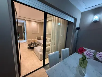 a living room with a table and a living room with a couch at Where to stay in Casablanca 2 bedrooms in Casablanca