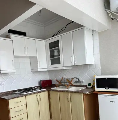a kitchen with white cabinets and a counter top at Un agréable studio au quartier Maarif à Casablanca in Casablanca