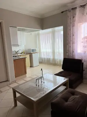a living room with a couch and a coffee table at Un agréable studio au quartier Maarif à Casablanca in Casablanca
