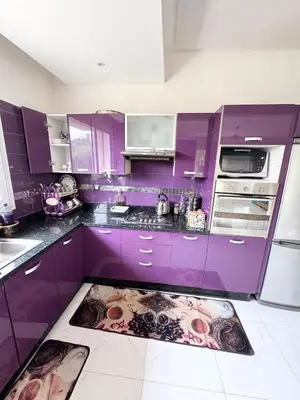 a purple kitchen with purple cabinets and a kitchen rug at Coastal serenity oasis in El Jadida