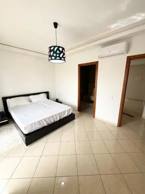 a bedroom with a bed and a pendant light at Coastal serenity oasis in El Jadida