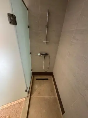 a small bathroom with a shower with a door at Coastal serenity oasis in El Jadida