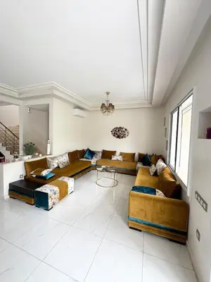 a living room with couches and a table at Coastal serenity oasis in El Jadida