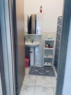 a bathroom with a sink and a mirror at Appartement cosy avec vue jardin à Casablanca ! in Casablanca