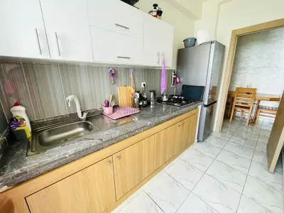 a kitchen with a sink and a refrigerator at Appartement cosy avec vue jardin à Casablanca ! in Casablanca