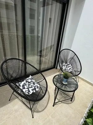 two chairs and a table on a balcony at Beautiful apartment with a terrace in Casablanca