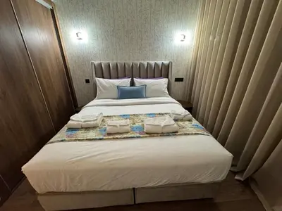 a bedroom with a large bed with two pillows at Beautiful apartment with a terrace in Casablanca