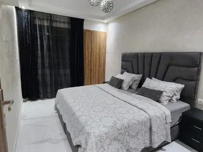 a bedroom with a large bed and a window at Malaga el Mansouria valence in Casablanca