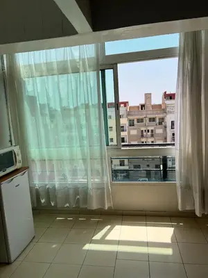 a kitchen with a large window with a view of a building at Un studio meublé agréable à Casablanca in Casablanca