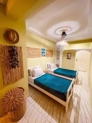 a bedroom with two beds and a chandelier at Cozy Studio in Casablanca in Casablanca