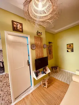 a living room with a door and a chandelier at Cozy Studio in Casablanca in Casablanca