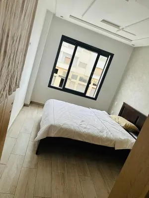 a bedroom with a large bed and a window at Appartement vu sur mer in Pont Blondin