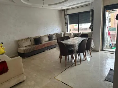a living room with a table and a couch at Appartement vu sur mer in Pont Blondin