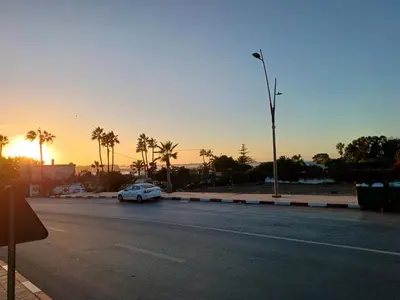 a car parked on the side of a road at sunset at الشروق 2 in Mansouria