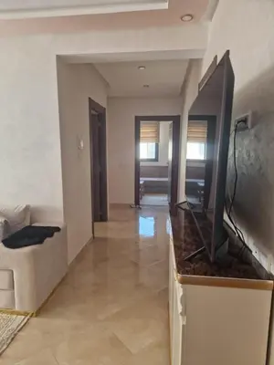 a living room with a flat screen tv on a counter at الشروق 2 in Mansouria