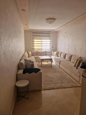 a living room with a couch and a table at الشروق 2 in Mansouria
