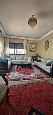 a living room with a couch and a rug at La corniche in Casablanca