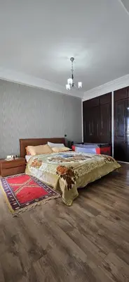 a bedroom with a large bed with a rug on the floor at La corniche in Casablanca