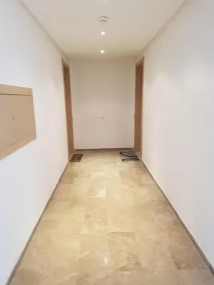 an empty room with white walls and a wooden floor at Luxury apartment in Hay Riad, Prestigia, Rabat in Rabat