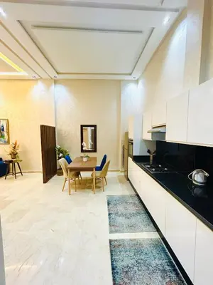 a kitchen and dining room with a table and chairs at Casablanca Luxury Studio Apartment Steps to the Beach in Casablanca