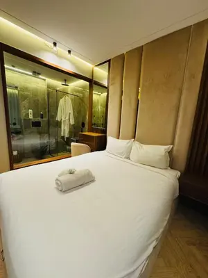 a bedroom with a white bed with a towel on it at CYPRessa Loft - Nature and Serenity - Corniche Access in Casablanca