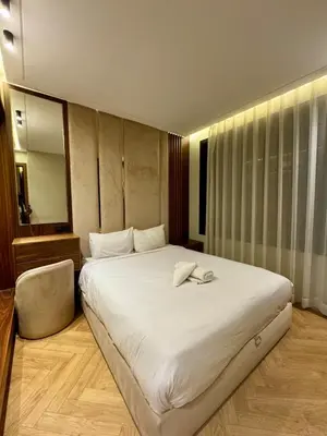 a bedroom with a large white bed and a mirror at CYPRessa Loft - Nature and Serenity - Corniche Access in Casablanca