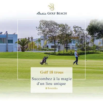 a man playing golf with a stroller on a golf course at Bahia Golf Beach Odyssée Appt Familial Bord De Mer in Bouznika