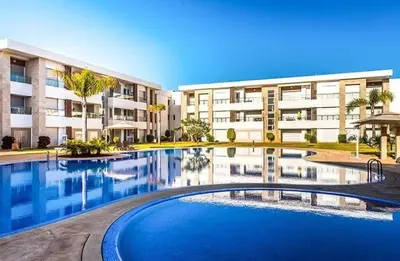 a large swimming pool in front of a building at Bahia Golf Beach Odyssée Appt Familial Bord De Mer in Bouznika