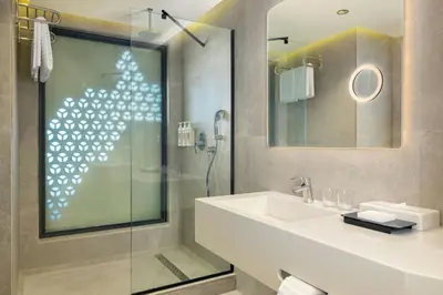 a bathroom with a sink and a shower at Le Meridien Casablanca in Casablanca