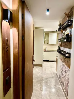 a kitchen with a hallway with a door and a stove at Domus Studio - Ambiance Zen au cœur de Casablanca in Casablanca