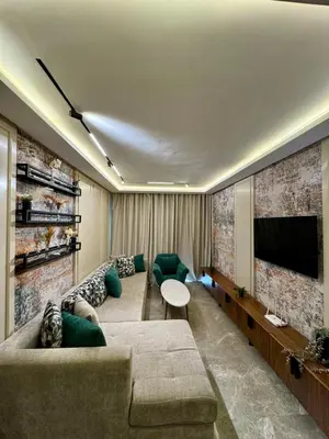 a living room with a couch and a flat screen tv at Domus Studio - Ambiance Zen au cœur de Casablanca in Casablanca