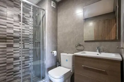 a bathroom with a toilet and a shower and a sink at Cozy Appartement Relax in Mohammedia