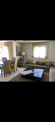 a living room with a couch and a table at Bahia golf beach bouznika in Bouznika