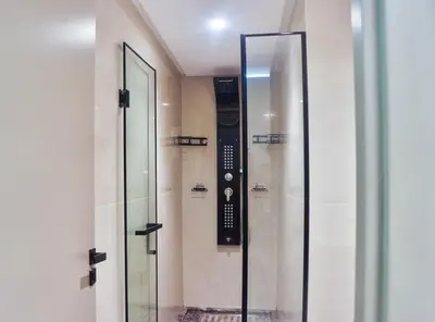 a glass shower in a building with a sign on the wall at Studio de luxe Vue Mer corniche casablanca in Casablanca