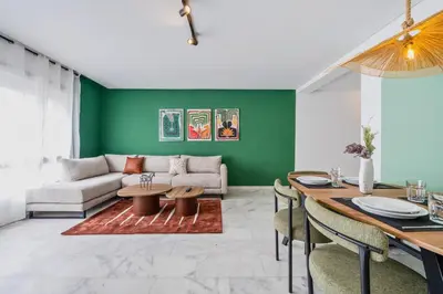 a living room with green walls and a table at CASA B l'hôtel in Casablanca