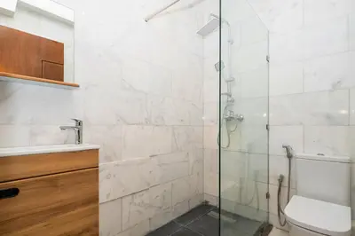 a bathroom with a glass shower and a toilet at CASA B l'hôtel in Casablanca