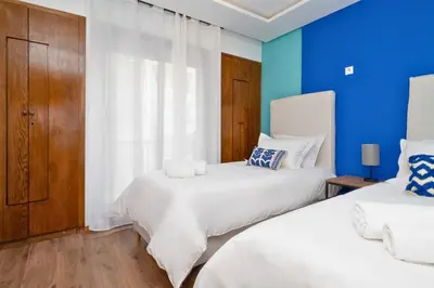 two beds in a room with blue walls at CASA B l'hôtel in Casablanca