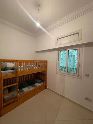 a room with two bunk beds and a window at Al kawtar Vacation apartment in Mansouria in O Ben Slimane