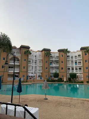 a large apartment complex with a large swimming pool at Al kawtar Vacation apartment in Mansouria in O Ben Slimane