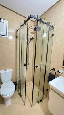 a bathroom with a shower with a toilet and a sink at Charming home in Temara in Temara