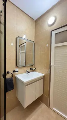 a bathroom with a sink and a mirror at Charming home in Temara in Temara
