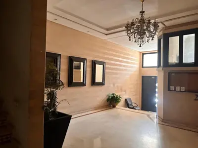 a large room with a chandelier and plants in it at Casa fbelvedère in Casablanca