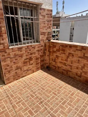 a brick building with a window and a brick patio at Casa fbelvedère in Casablanca