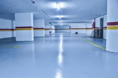 an empty parking garage with white walls and blue floors at Studio de charme face corniche de Casablanca in Casablanca