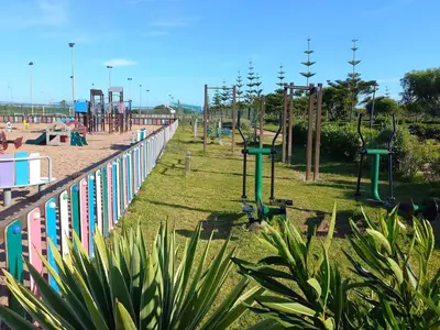 a park with a playground with a play area at Appartement avec Terrasse, Piscine & Plage à Ola Blanca 2 in Sidi Rahal