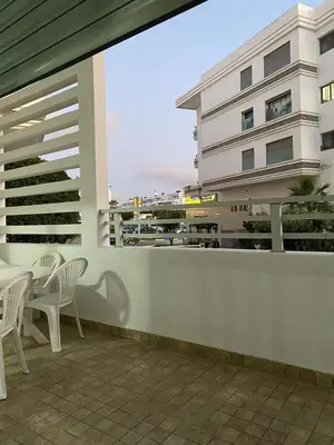 a balcony with chairs and a table and a building at Apartment in a residence in Pont Blondin