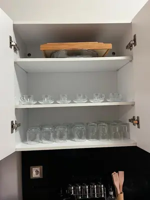 a cupboard filled with lots of glass dishes at Apartment in a residence in Pont Blondin